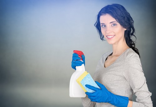 Professional carpet cleaner working safely in a living room